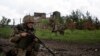 Soldados ucranianos patrullan el domingo 15 de mayo de 2022 en una población al norte de Járkiv, en el este de Ucrania. (AP Foto/Mstyslav Chernov)