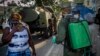 Un soldado de las fuerzas armadas usa una máscara como protección mientras limpia una calle con solución de cloro en La Habana. . (AP/Ramon Espinosa)